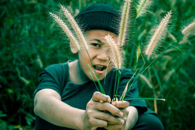 Portrait of man holding plant