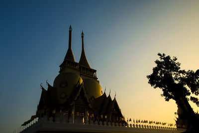 Low angle view of temple against clear sky at dusk