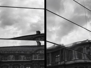 Low angle view of building against cloudy sky