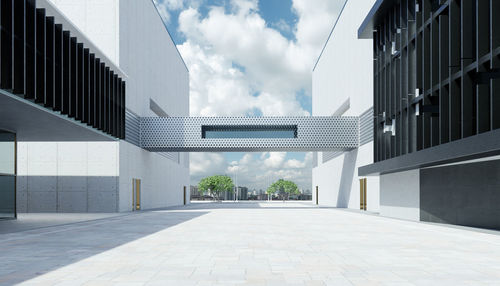 Modern building against cloudy sky