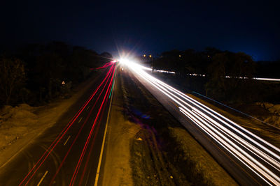 High angle view of light trails on highway at night