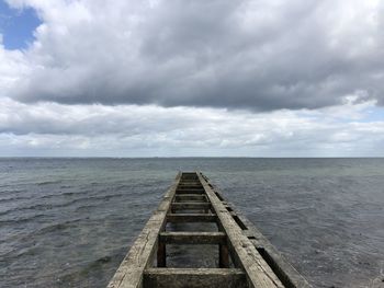 Pier over sea against sky