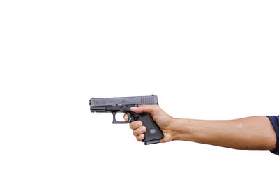 Low angle view of hand holding hands against white background