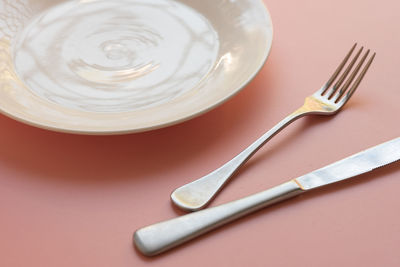 High angle view of fork in plate on table