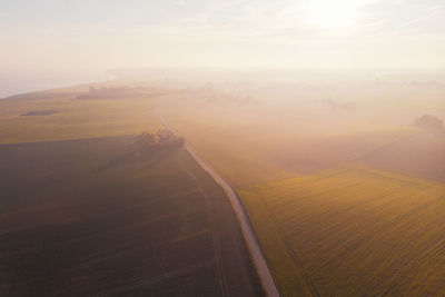 Aerial view of road by land against sky