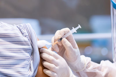 Midsection of person holding cigarette