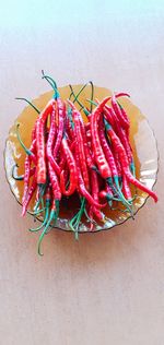 High angle view of red chili peppers on table