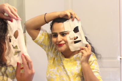 Close-up of woman with facial mask at home