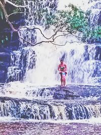 Full length of woman standing on rock