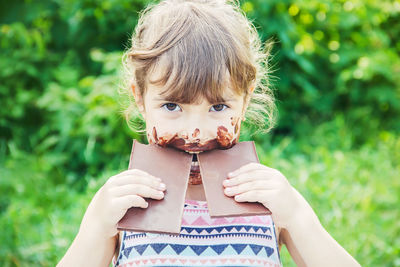 Portrait of young woman blowing bubbles