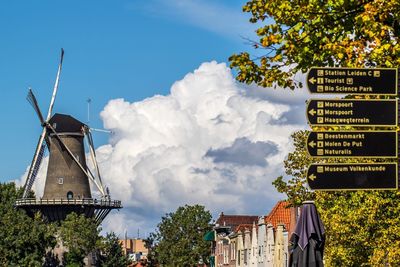 Low angle view of traditional windmill against sky