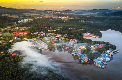 High angle view of buildings by sea against sky