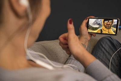 Midsection of woman holding smart phone