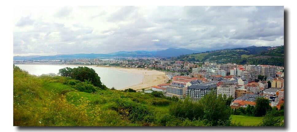 VIEW OF CITYSCAPE WITH MOUNTAIN RANGE IN BACKGROUND