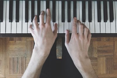 Midsection pianist playing piano