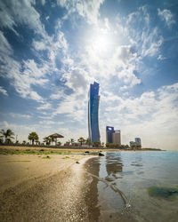 Building by sea against sky in city