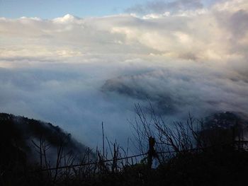 Scenic view of landscape against cloudy sky