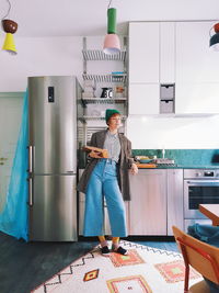 Full length of man photographing on table at home