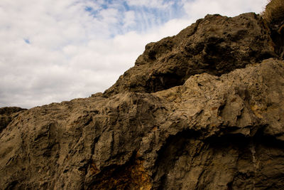 Low angle view of rock formations against sky