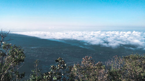 High angle view of sea and mountains against sky