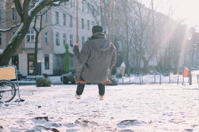 Rear view of man on swing