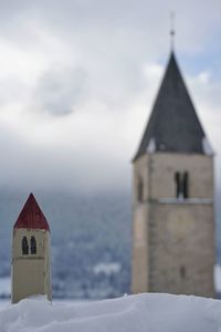 Close-up of bell tower against sky during winter