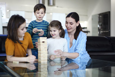 Portrait of mother and daughter sitting at home