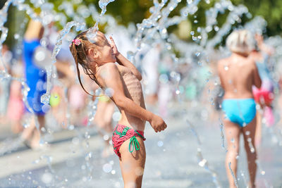 Low section of woman walking in water