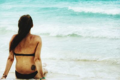 Rear view of woman looking at sea