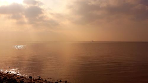 Scenic view of sea against sky at sunset