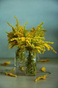 Close-up of yellow flowering plant on table