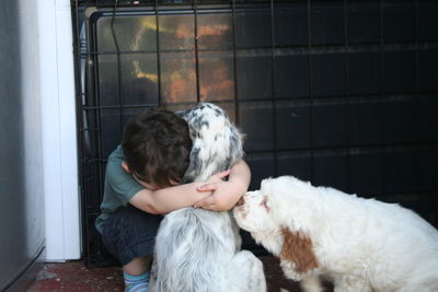 Boy embracing a puppy