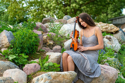 Woman sitting on rock