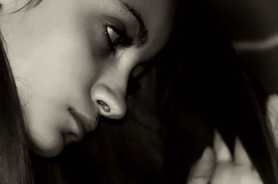 Close-up of girl lying down indoors