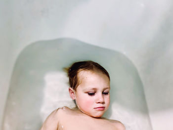 Portrait of shirtless boy in water