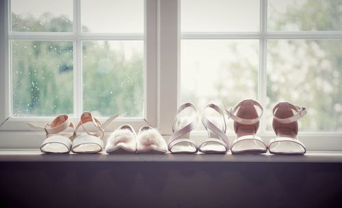 High heels arranged on window sill