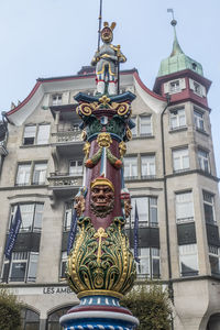 Low angle view of statue against building