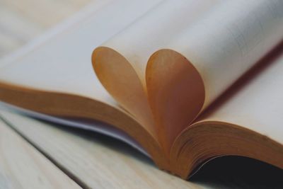 Close-up of heart shape pages in book