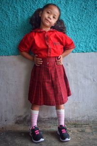 A cute little girl is happy to wear a new school uniform, new semester of school
