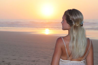 Woman at beach during sunset