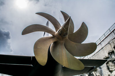 Low angle view of submarine propeller against sky