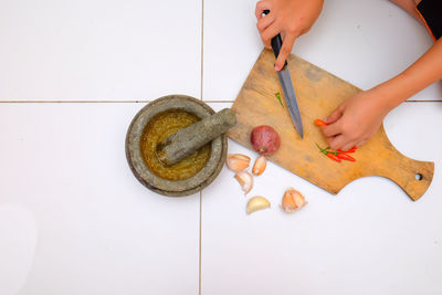 High angle view of woman preparing food on cutting board