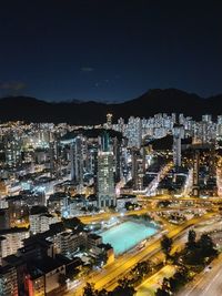 High angle view of city lit up at night