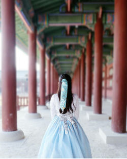 Rear view of woman walking in temple  japan. 