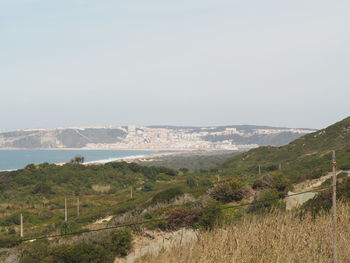 Scenic view of landscape with sea in background