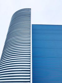 Close-up of modern office building against sky