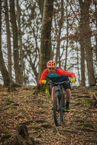 Man riding bicycle in forest