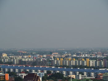 High angle view of buildings in city against clear sky