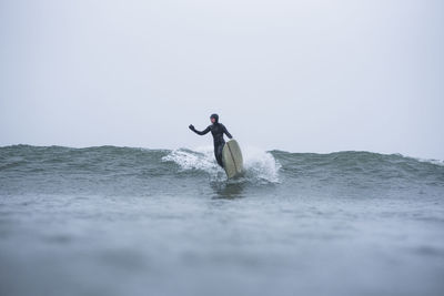 Woman surfing during winter snow