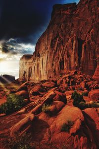 Low angle view of rock formation against cloudy sky